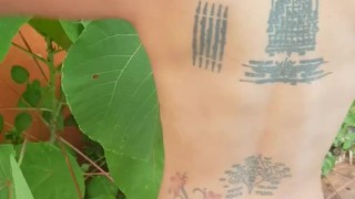 Slave May is showing her tattoos next to the swimming pool