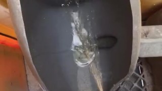 Taking a leak in the Port a Potty 