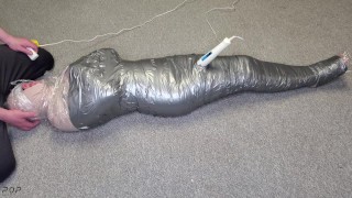Harley Quinn wrapped in layers of mummification bondage then teased with a wand & made to cum