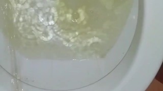 Peeing standing up in a dirty toilet