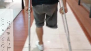 Amputee guy walking with crutches