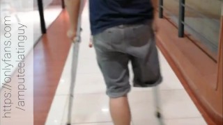 Amputee guy walking with crutches