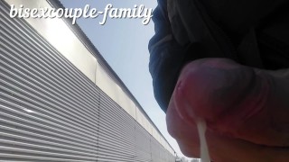 Jerking off and cumming at the railway crossing behind the fence people work