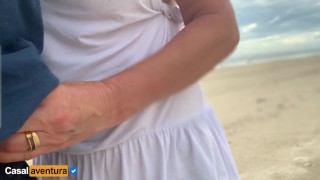 She loves to make a handjob on the crowded beach