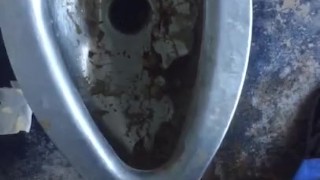 Taking a leak in a nasty outdoor public bathroom 