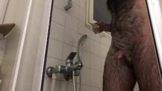 Very hairy man shave while bathing 