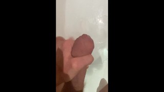 Horny big cock guy wanking in the bath, cumming in bathwater over feet, masturbating uncut big dick