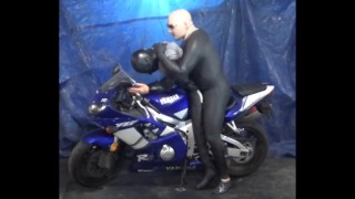 having some fun sitting on the motorcycle with dummy