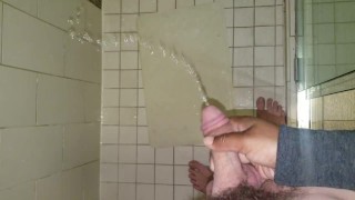 Penis Envy. Shooting his piss all over in the hotel shower! Holding his dick while he pees.