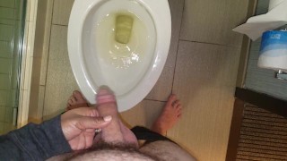 She aims his dick at the hotel toilet