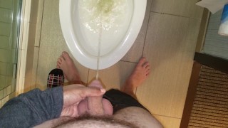 She aims his dick at the hotel toilet
