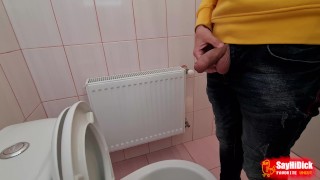 Uncircumcised cock pees on the station toilet