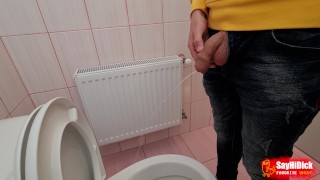 Uncircumcised cock pees on the station toilet