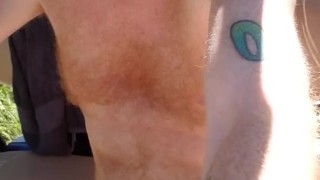 Ginger getting naked outdoors stroking his cock