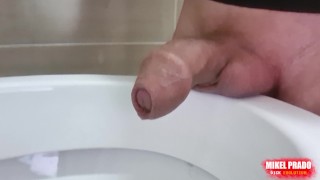 Uncircumcised cock peeing with a big stream