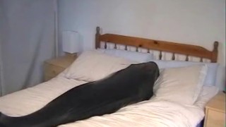 Cute girl in black latex catsuit with mask makes self bondage in rubber vacuum sleepbag - part 2