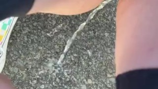 slut pisses outside during the day