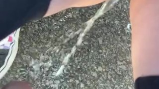 slut pisses outside during the day
