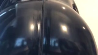 Rubber gimp in chastity shows off 
