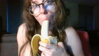girl with cute glasses sucks banana