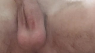 Skinny boy shaves his pubic hair on his dick while sitting on the floor