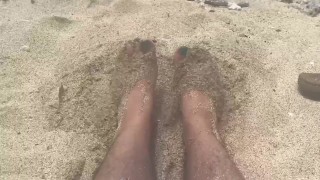 rubbing my feet in the sand on the beach 
