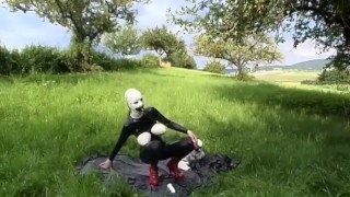 Rubber Girl Full in Black Latex Catsuit and Mask Plays with herself Outdoor in a Meadow - Part 3