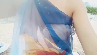 Funny girl with pink nipples exposed on public beach