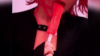 Goth babe licking & sucking red blowpop