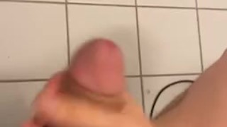 man jerks himself on the toilet.