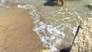 Alice is relaxing on the sea on a wild beach with a butt plug in the ass
