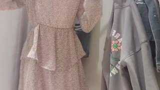 Russian sudent trying on a dress in a fitting room