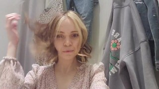 Russian sudent trying on a dress in a fitting room