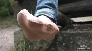 Jeans Feet In Nylon Socks In The Forest