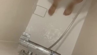 Japanese guy pissing while taking a shower
