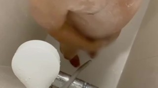 Japanese guy pissing while taking a shower