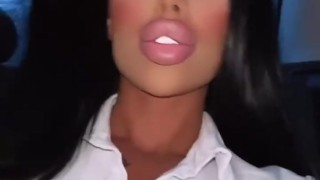 Lara Frost in a secretary costume rides in a car