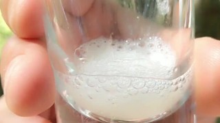 Spitting guy´s thick cum to the glass and drinking it again after blowjob outdoor