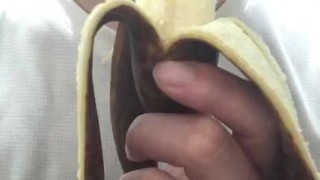 Peel and eat a large, black banana by hand.
