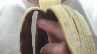 Peel and eat a large, black banana by hand.