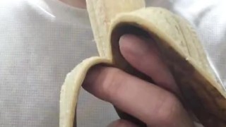 Peel and eat a large, black banana by hand.