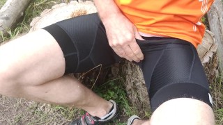 A cyclist in bib shorts is jerking off a cock and swallow cum.