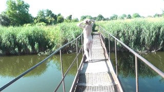 Messalina Dressed in Sun. Outside Outdoor. Nude Milf walks by bridge River. Naturist Nudist Woman