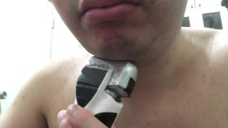 Shaving my beard with a shaver.