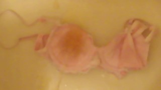 pissing on cup of pink bra!