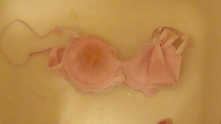 pissing on cup of pink bra!
