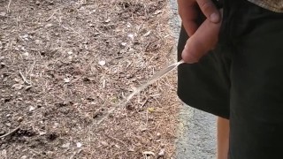 Boy peeing outside cabin