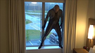 silicone masked wetsuited guy gets horny at hotel window and humps his pillows