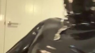 Gagged rubber gimp jerks off