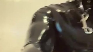 Gagged rubber gimp jerks off